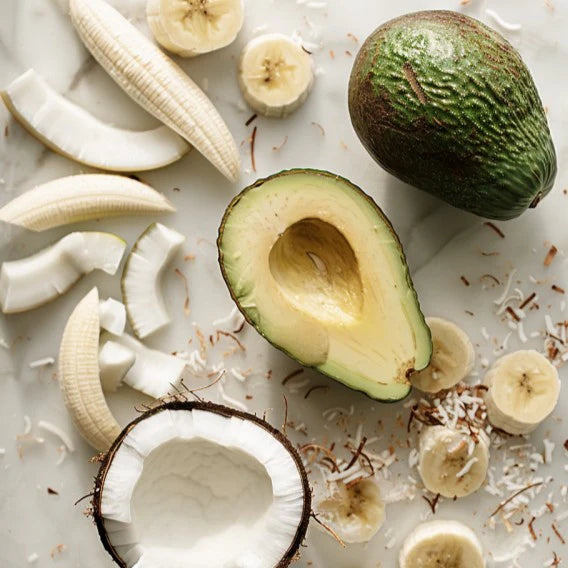 Kuvings smoothie ingredients with avocado, bananas and coconuts on a light surface for healthy homemade juice and smoothie recipes.