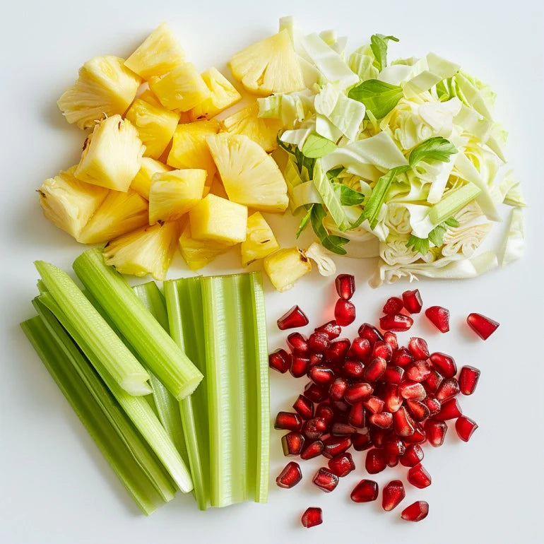 Kuvings juice ingredients with chopped pineapple, celery and pomegranate