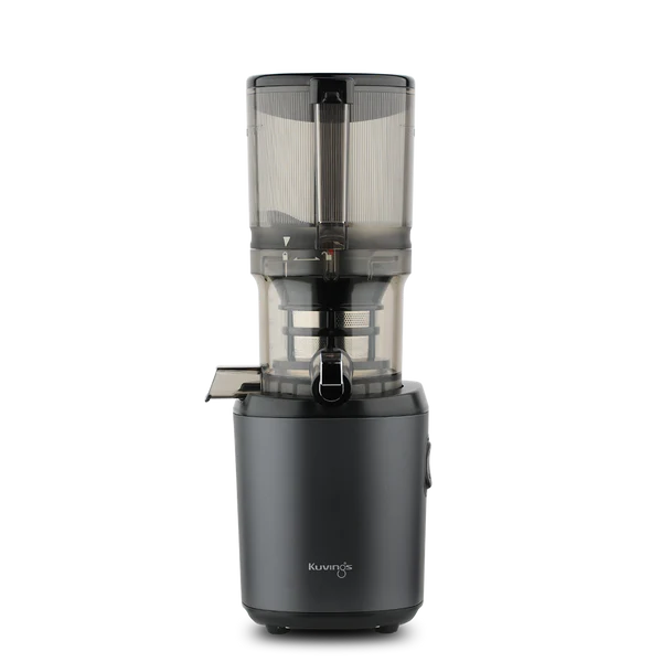 Straight-on studio product shot of a graphite grey Kuvings AUTO6 whole slow juicer with its transparent grey mega-hopper container attached, isolated against a transparent grid background.