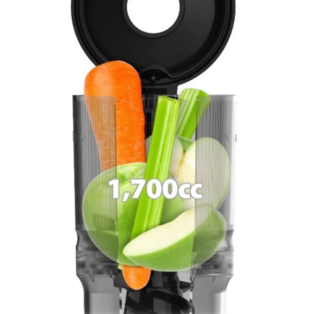 Close-up studio product shot of the transparent grey mega-hopper on a Kuvings AUTO6 slow juicer filled with a whole carrot, celery stalk, and sliced green apples, featuring white "1,700cc" overlay text indicating capacity.