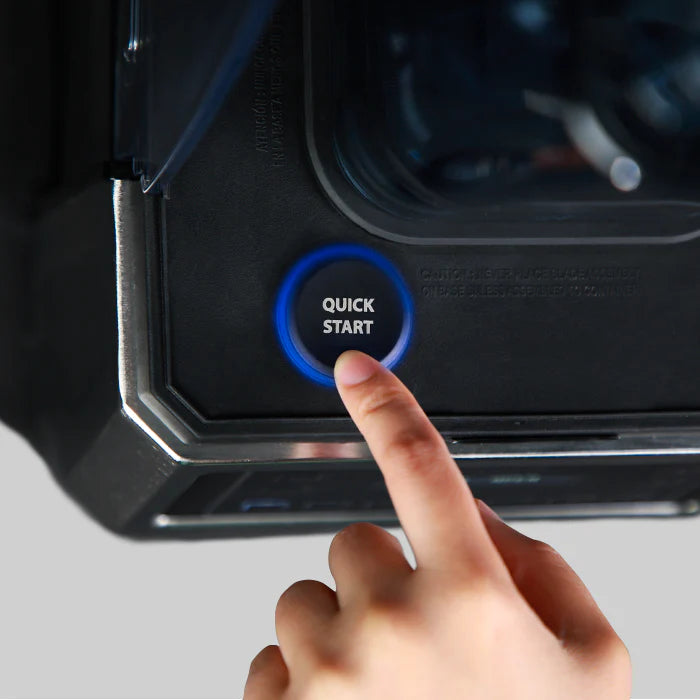 Close-up view of a finger pressing the circular 'QUICK START' button illuminated with a blue LED ring on the base of a Kuvings CB1000 commercial blender.