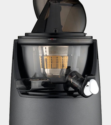 Straight-on close-up studio product shot of the middle assembly section of a gunmetal grey Kuvings EVO820 whole slow juicer, showcasing its transparent dark grey juicing bowl that reveals the fine metal mesh juicing strainer and orange rotation wiper inside, positioned below the base of the feeding chute against a light grey background.