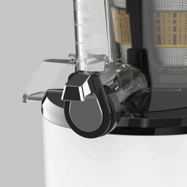 Close-up studio product shot of the transparent juicing bowl on a white Kuvings REVO830 whole slow juicer, showing the closed chrome-accented smart cap and pulp spout on a grey background.
